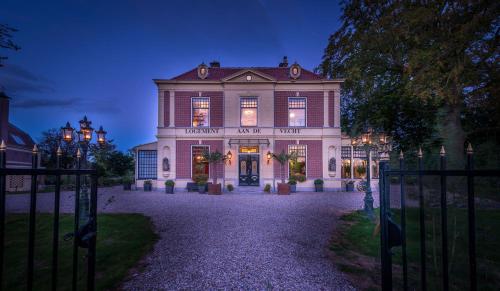 a large house with a gate in front of it at Logement aan de Vecht in Breukelen
