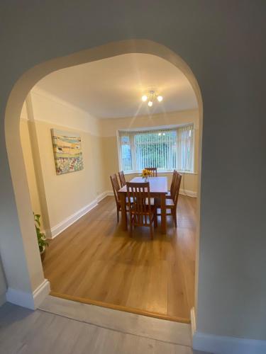 an archway in a dining room with a table and chairs at Spacious Dinnington bungalow in Dinnington