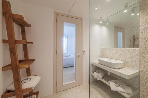 a bathroom with a sink and a mirror at Penthouse Villa with Private Pool, Sauna & Seaview in Gialova