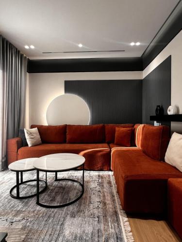 a living room with a couch and a table at Noir luxury apartment in Durrës