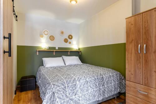 a small bedroom with a bed and green walls at Studio 35 - Modern & Cozy Studio in Chalandri City Center in Athens