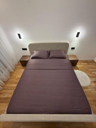a bedroom with a large bed in a room at ZONE apartments in Prishtinë