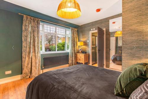 a bedroom with a large bed and a window at Ideal Stay for Business Travellers, Contractors, and Families near NEC, Belfry, Birmingham Resorts World, and Drayton Manor in Birmingham