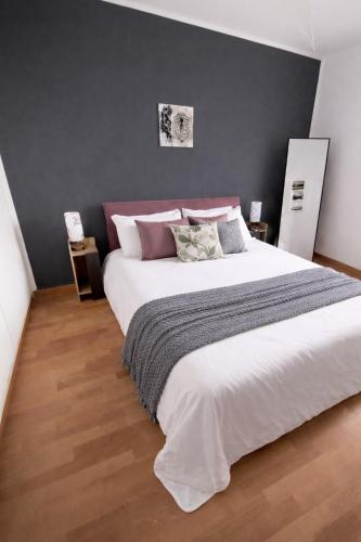 a bedroom with a large white bed with pillows at VM Ravenna Luxury Apartment in Ravenna
