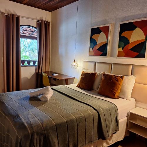 a bedroom with a bed in a room at Pousada Schueng in Trindade