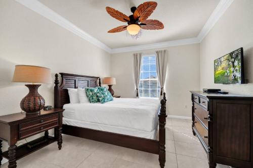 a bedroom with a bed and a ceiling fan at Top Floor*Balcony*VistaCay Convention Ctr & Idrive in Orlando