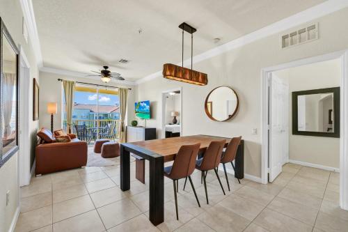 a dining room and living room with a table and chairs at Top Floor*Balcony*VistaCay Convention Ctr & Idrive in Orlando