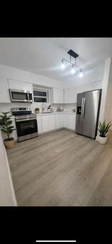 a kitchen with a stainless steel refrigerator and appliances at Santorini Hollywood in Hollywood