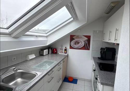 a kitchen with a sink and a skylight at Gemütliche 3 Zimmerwohnung in Ühlingen-Birkendorf