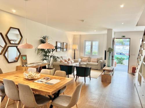 a dining room and living room with a table and chairs at Toi et Moi-Guests speek for us! in Ponta Delgada