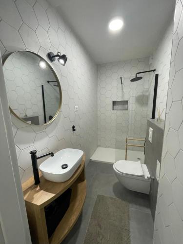 a bathroom with a sink and a toilet and a mirror at Apartments Ula in Vodice