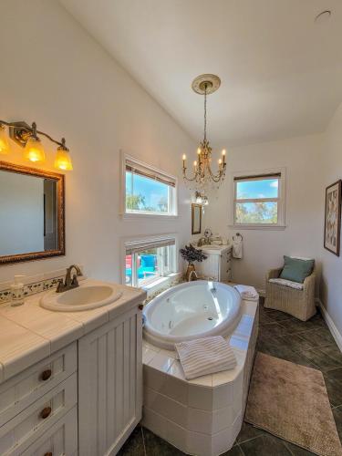 a bathroom with two sinks and a large tub at Beverlys Hilltop Retreat in Fallbrook