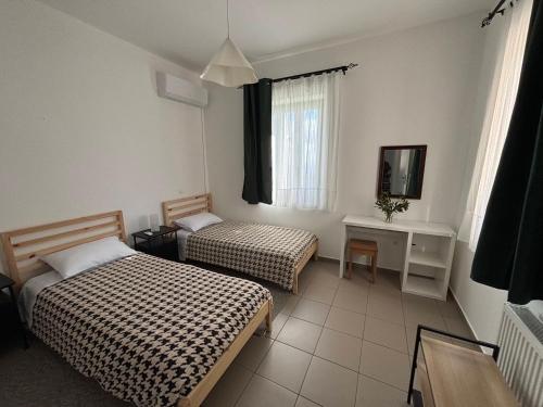 a hotel room with two beds and a television at Horizon in Kythira