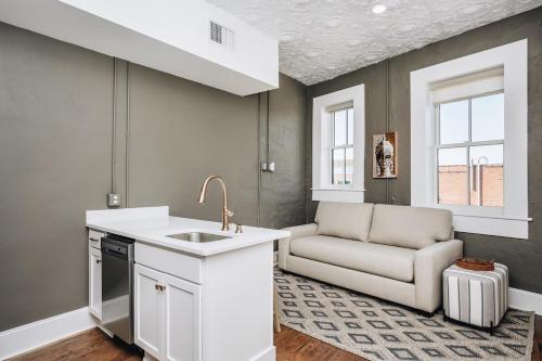 a kitchen with a sink and a couch at The Harriss in Wilson
