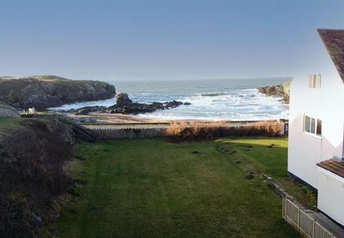a view of the ocean from a house at GWYNFA-3 BED- GROUND FLOOR APT - SEA VIEWS - TREARDDUR BAY in Trearddur