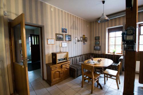 a living room with a table and a tv at Svečių namai Lingės in Nemėžis