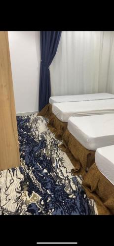 a row of three mattresses sitting in a room at فندق اوتاد المتحدة المعابدة in An Naqāʼ