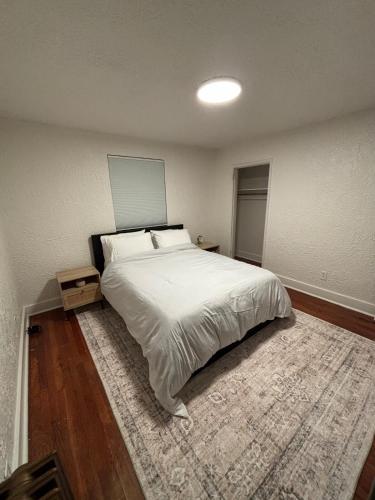 a bedroom with a large bed and a rug at Pittsburgh Getaway - Private Home- 2 Beds in Pittsburgh