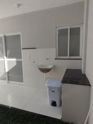 a bathroom with a sink and a counter and a toilet at AZURE residence in Caucaia