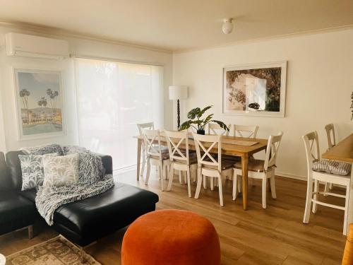 a living room with a dining room table and chairs at THE PHILLY in Cowes