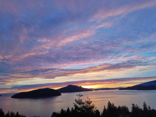 a sunset over a large body of water at Vancouver sea view Palace inn in West Vancouver