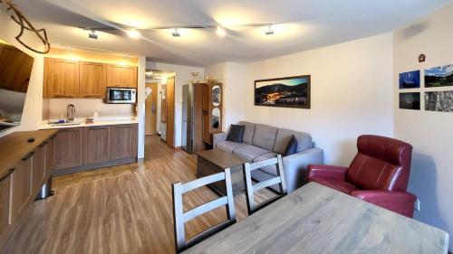 a kitchen and a living room with a table and chairs at Cahilty #316 home in Sun Peaks
