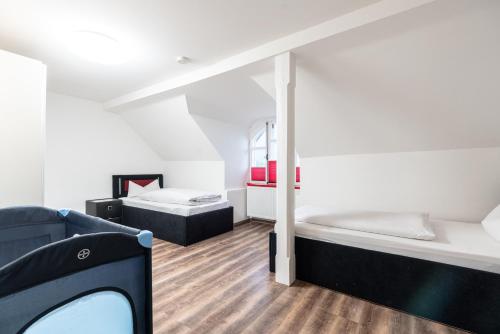 a room with two beds and a tv in it at Ferienwohnungen Ammerwinkel in Oberammergau