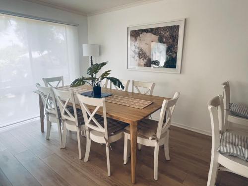 a dining room with a wooden table and chairs at THE PHILLY in Cowes