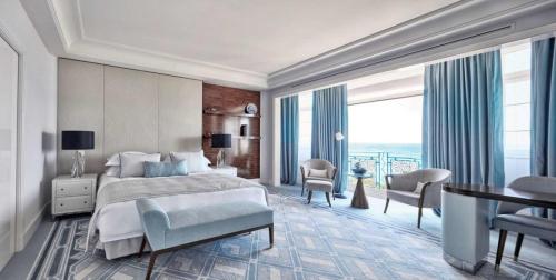 a bedroom with a large bed and a large window at Oscar Apartments in Cairo