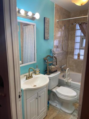 a bathroom with a sink and a toilet and a tub at Cozy room in house at Airport & Highway in Saint Louis