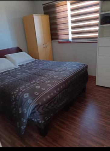 a bedroom with a bed in a room with a window at Cabaña Quillaycillo in La Rudilla