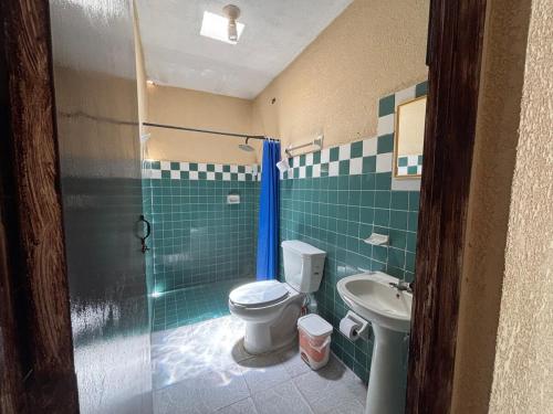 a bathroom with a toilet and a sink at House 30 meters from the sea in Chicxulub