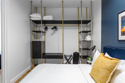 a bedroom with a bed with a gold and black bed frame at Mint House Dallas Downtown By Kasa in Dallas