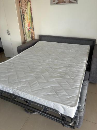 a mattress on a bed frame in a room at Magnifique appartement COZY proche de la mer in Le Moule