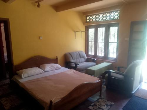 a bedroom with a bed and a chair at Sehandi Hotels - Renaissance Ella in Ella