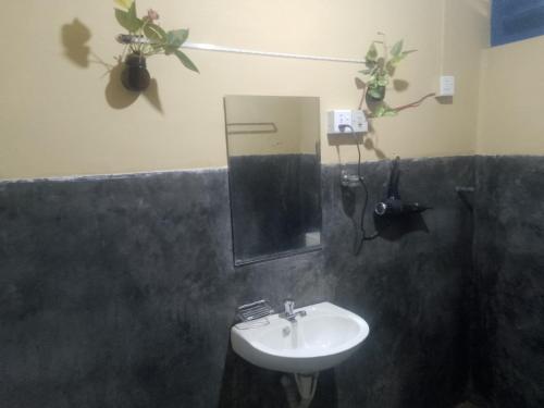 a bathroom with a sink and a mirror at Sehandi Hotels - Renaissance Ella in Ella