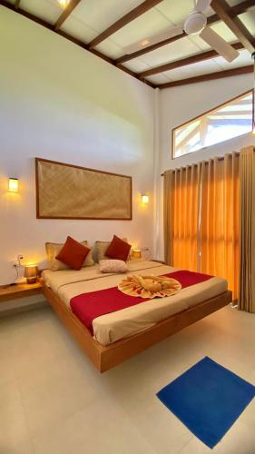 a bedroom with a large bed in a room at The Tottam Beach Hotel - Trincomalee in Trincomalee