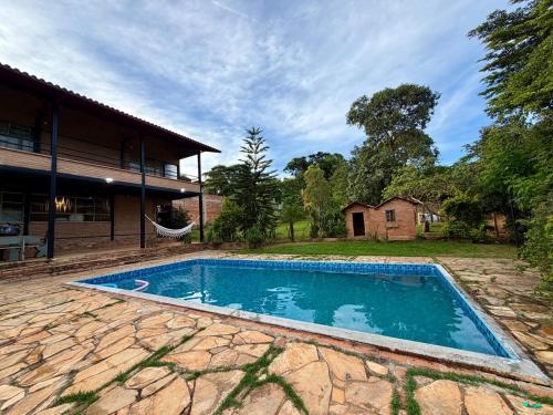 a swimming pool in front of a house at Recanto do Amaral - Espaço de Lazer e Eventos in Betim