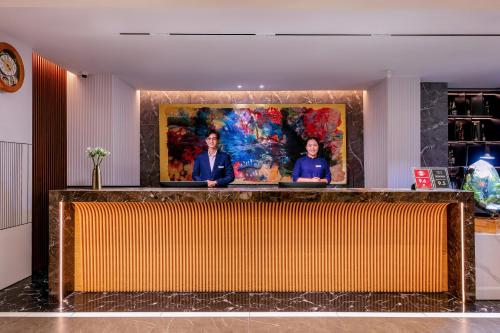 a lobby with a painting on the wall at GRAND CITITEL Hanoi Hotel & Spa in Hanoi