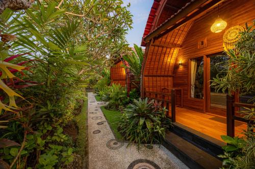 a pathway leading to the front of a house at Cove Jiwana Villa in Nusa Dua
