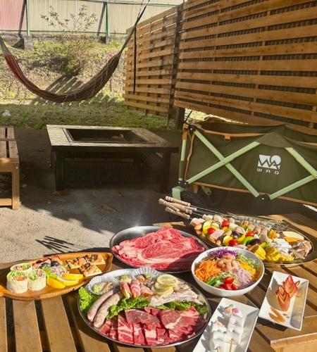 a table with many different types of food on it at グランコテージベンガルの森 in Nasu