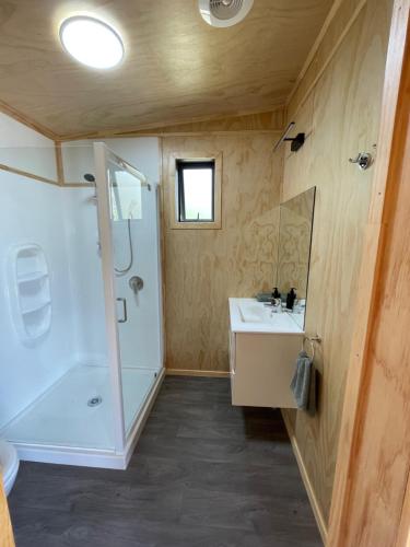 a bathroom with a shower and a sink at Rural Getaway in Thames