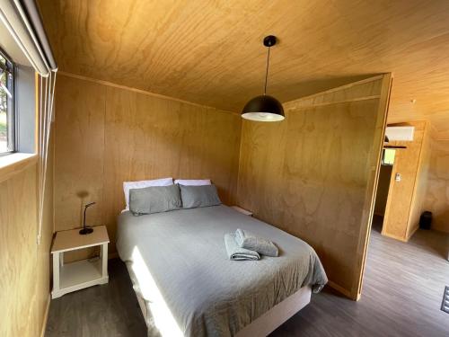 a bedroom with a bed in a small room at Rural Getaway in Thames