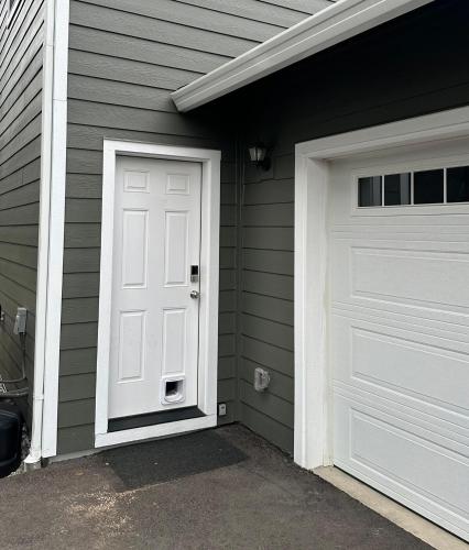 a house with a white door and a garage at Studio in North Bend in North Bend