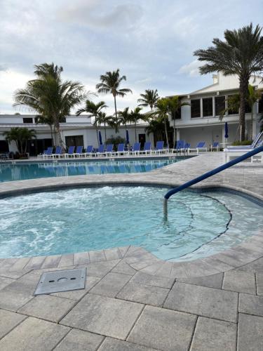 a swimming pool with a hose in the water at Casa SolMar in Fort Pierce