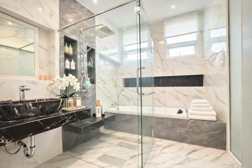 a bathroom with a shower and a sink and a tub at Kamala Beach Phuket - 4BR Private Luxury Pool Villa with Maid in Kamala Beach