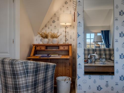 a room with a table and a sink in it at Boutiquehotel Seiler Hof Keitum in Keitum