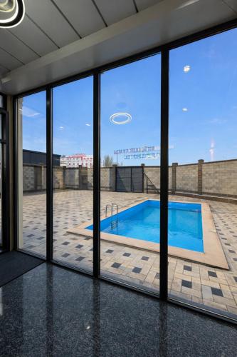 a view of a swimming pool through a window at Huaxia Hotel Bishkek in Bishkek