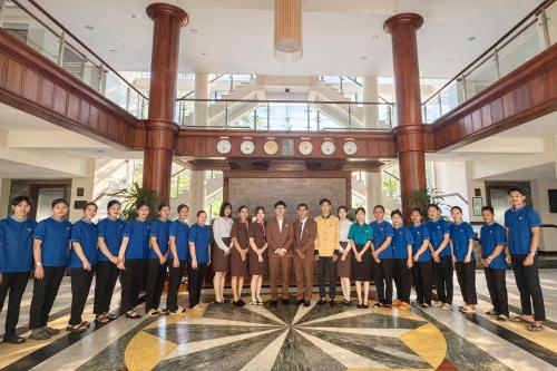 a group of people posing for a picture in a building at EG Paradise Angkor Villa Hotel in Siem Reap