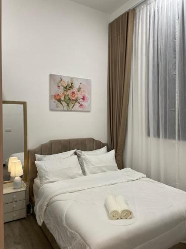 a bedroom with a bed with two towels on it at ResidenShals in Putrajaya